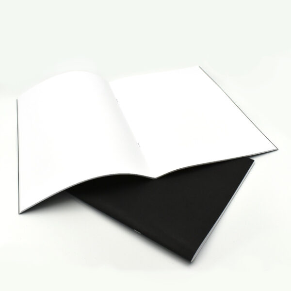 åben sort noteshæfte med blanke sider